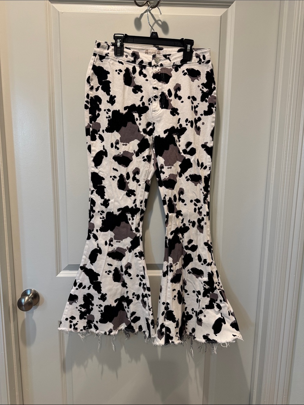 Altar'd State Black and White Cow Print Flare Jeans